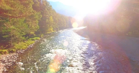 Low altitude flight over fresh fast mountain river with rocks at sunny summer Video stock 115090384