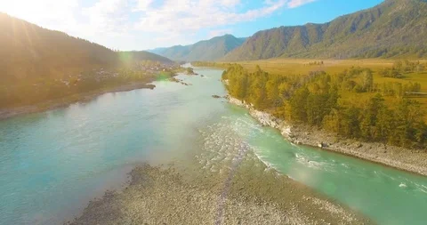 Low altitude flight over fresh fast mountain river with rocks at sunny summer Stock Footage 115092302