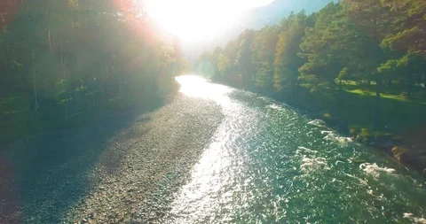 Low altitude flight over fresh fast mountain river with rocks at sunny summer Stock Footage 127344611
