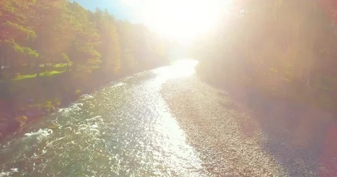 Low altitude flight over fresh fast mountain river with rocks at sunny summer Stock Footage 127345181
