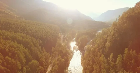 Low altitude flight over fresh fast mountain river with rocks at sunny summer Stock Footage 127349364