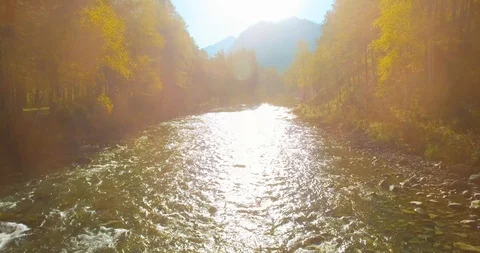 Low altitude flight over fresh fast mountain river with rocks at sunny summer Stock Footage 127351573