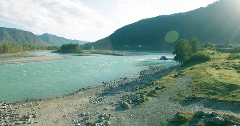 Low altitude flight over fresh fast mountain river with rocks at sunny summer Stock Footage 127354018