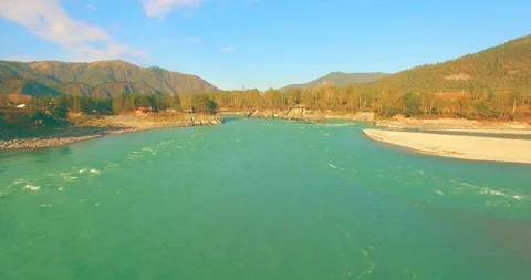Low altitude flight over fresh fast mountain river with rocks at sunny summer Stock Footage 127354094