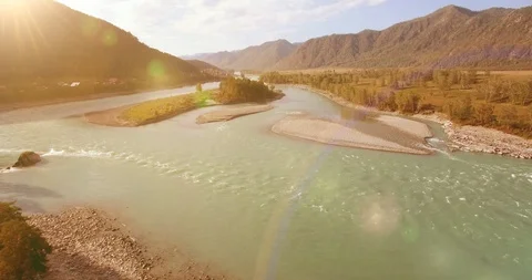 Low altitude flight over fresh fast mountain river with rocks at sunny summer Stock Footage 127355223