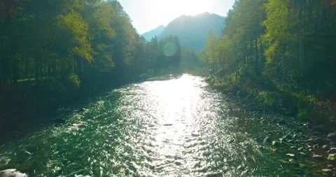 Low altitude flight over fresh fast mountain river with rocks at sunny summer Stock Footage 133269733