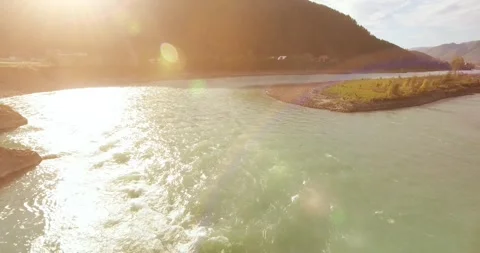 Low altitude flight over fresh fast mountain river with rocks at sunny summer Stock Footage 285477479