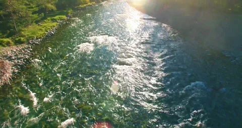 Low altitude flight over fresh fast mountain river with rocks at sunny summer Stock Footage 285477846