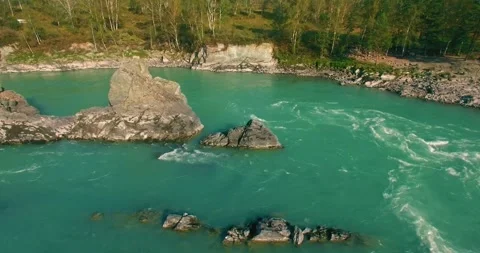 Low altitude flight over fresh fast mountain river with rocks at sunny summer Stock Footage 290442095