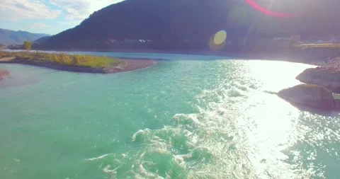 Low altitude flight over fresh fast mountain river with rocks at sunny summer Stock Footage 291782528