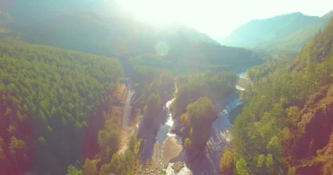 Low altitude flight over fresh fast mountain river with rocks at sunny summer Stock Footage 291783349