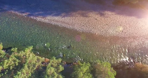 Low altitude flight over fresh fast mountain river with rocks at sunny summer Stock Footage 294422446
