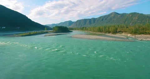 Low altitude flight over fresh fast mountain river with rocks at sunny summer Stock Footage 294428977