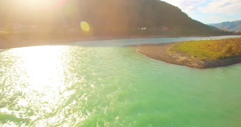 Low altitude flight over fresh fast mountain river with rocks at sunny summer Stock Footage 294489270