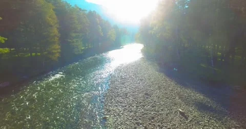 Low altitude flight over fresh fast mountain river with rocks at sunny summer Stock Footage 294489784