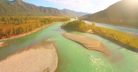 Low altitude flight over fresh fast mountain river with rocks at sunny summer Stock Footage 310717679