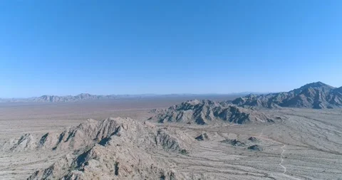 Low altitude flight over harsh terrain in the desert aerial drone shot Stock Footage 147253855