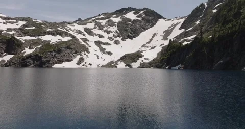 Low Altitude Fly Over of Alpine Lake Stock Footage 313955532