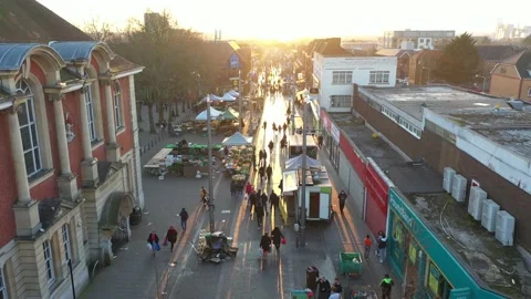LOW ALTITUDE FLY OVER CROWDED EAST LONDON STREET MARKET SUNDOWN Stock-Footage 150006645