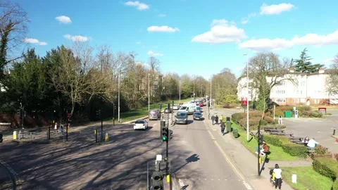 LOW ALTITUDE FLY OVER VEHICLES IN A TRAFFIC LIGHT IN A SUNNYDAY, ENGLAND, UK 스톡 동영상 150170179