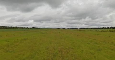 Low Altitude Forward Drone Flight Over Summer Field Under Cloudy Sky - 2 Video stock 327328805