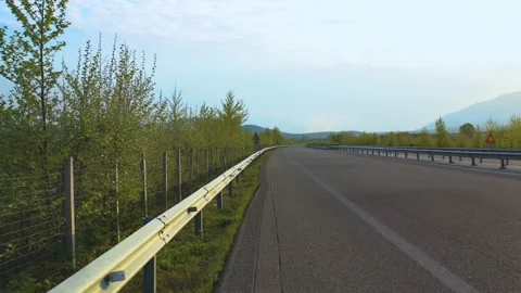 Low altitude forward video of highway lane at susnet Video stock 132562846