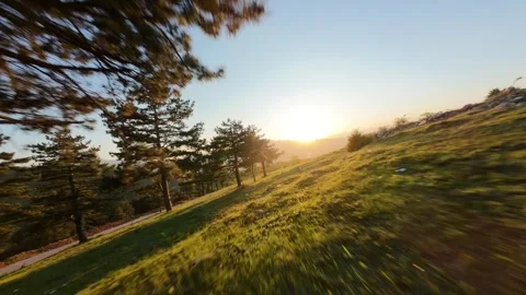 Low Altitude FPV Drone Gliding Through Mountain Peaks at Sunset Stock Footage 328599286