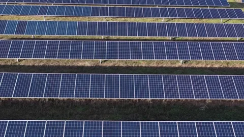 Low altitude slow forward motion over solar panel rows Stock Footage 327812299