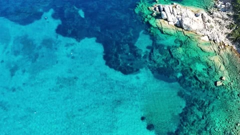 Low Altitude Top-Down Drone Flight Over Turquoise Waters and Rocky Shore Stock Footage 332721801