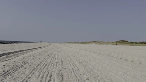 Low angel view of tire tracks on the beach. Jacob Riis Park.Queens. New York Stock Footage 220732970