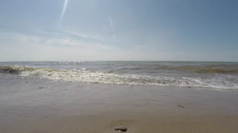Low angle 4k view of waves crashing on sandy Lake Michigan Beach Video stock 52481420
