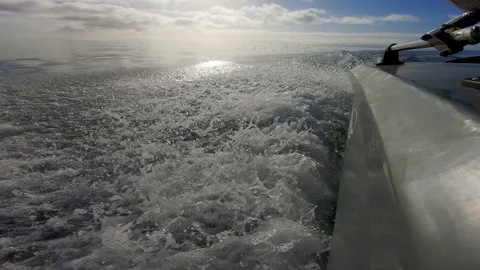 Low angle action cam looking back fishing boat heading out to sea Stock Footage 114715177