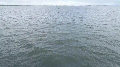 Low angle aerial drone shot over the Irish sea towards a boat. 스톡 동영상 120430591