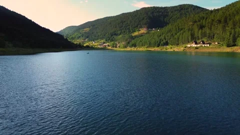 Low angle aerial flyover shot over water surface of Zaovine Lake Serbia Stock Footage 342241745