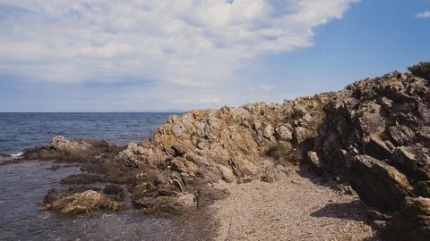 Low angle aerial view of rocky coast, Rocks in the sea Stock Footage 106187917