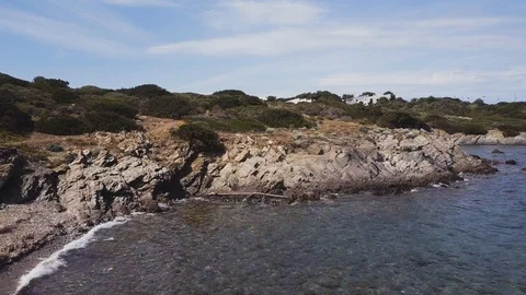 Low angle aerial view of rocky coast, Rocks in the sea Stock Footage 106187969