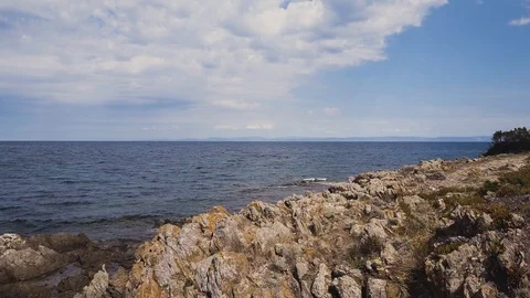 Low angle aerial view of rocky coast, Rocks in the sea Stock Footage 106187978