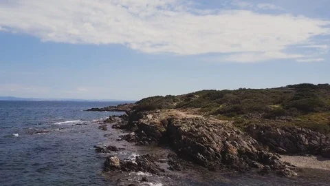 Low angle aerial view of rocky coast, Rocks in the sea Stock Footage 106188148