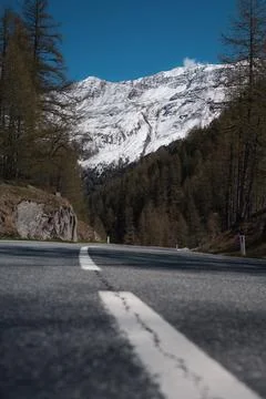 Low Angle Alpine Road Leading to Snowy Mountains in Tyrol Austria Stock Photos