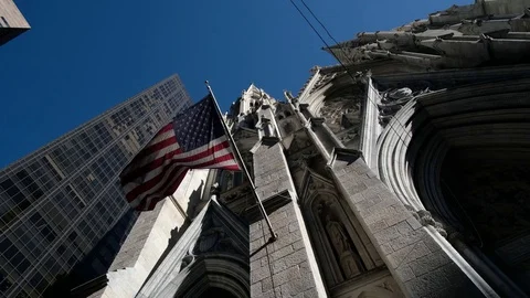 Low angle american flag fluttering at Saint Patrick Church in New York Stock Footage 81424435