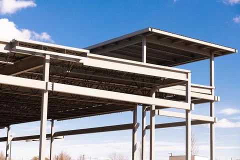 Low angle and diagonal view of yellow metal building roof structure in constr Stock Photos