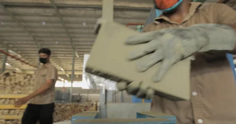 Low Angle and Shallow Focus Shot of Worker Brushing Off Battery Separator (4K) Stock Footage 60787032