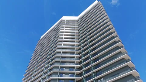 Low angle arc shot of impressive architectural structure against fair sky Stock Footage 254577625