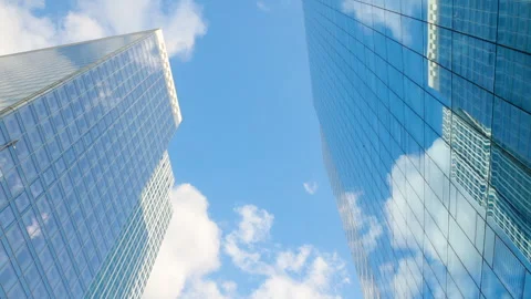 Low-angle architectural view looking up between two modern glass skyscrapers ref Stock Footage 338027448