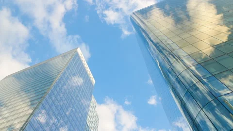 Low-angle architectural view looking directly up at two modern corporate glass s Stock Footage 338027453