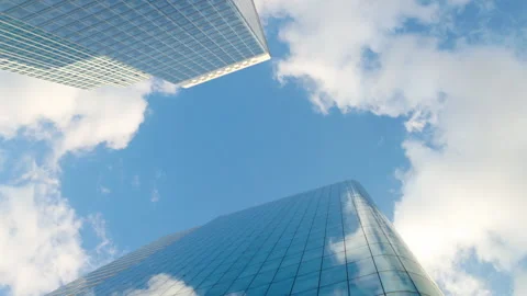 Low-angle architectural view looking straight up into the sky between modern gla Stock Footage 338027498