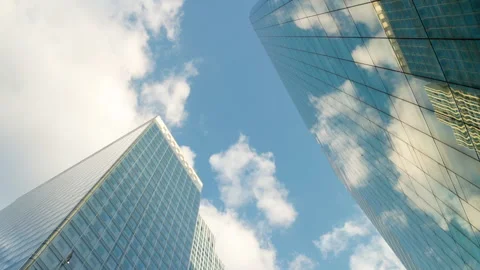 Low-angle architectural view looking up between modern corporate skyscrapers wit Stock Footage 338027530