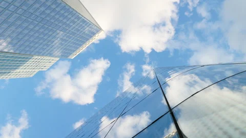 Low-angle architectural view looking straight up into the sky between modern gla Stock Footage 338027547