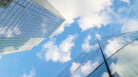 Low-angle architectural view looking straight up into the sky between modern gla Stock Footage 338027553
