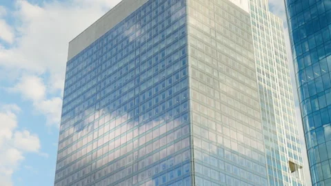 Low-angle architectural view of modern glass office skyscrapers in a commercial  Stock Footage 338027132